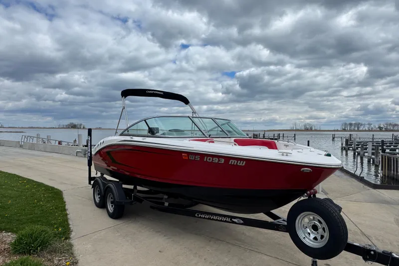 Slide: The Image of 2017 Chaparral 21 H2O Sport boat on trailer by a lake under cloudy skies. - 4