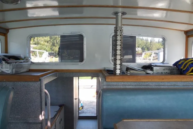 Slide: The Image of Interior of a 2007 Armstrong Marine 36 Catamaran with windows and seating. - 11