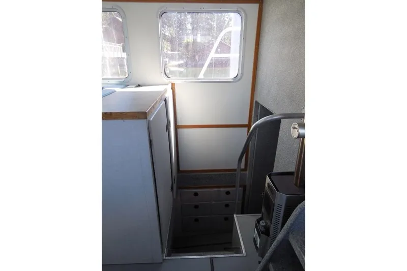 Slide: The Image of Interior of 2007 Armstrong Marine 36 Catamaran with stairs and windows. - 12