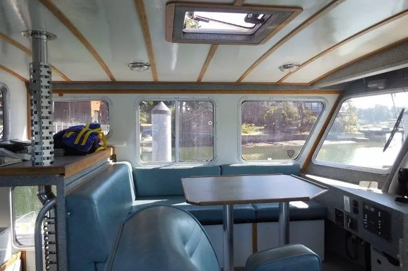 Slide: The Image of Interior of 2007 Armstrong Marine 36 Catamaran with seating and table. - 13