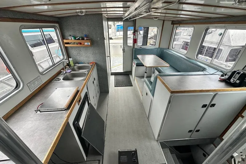 Slide: The Image of Interior of a 2007 Armstrong Marine 36 Catamaran featuring a kitchen and seating area. - 14