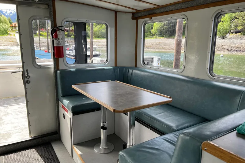 Slide: The Image of Interior of a 2007 Armstrong Marine 36 Catamaran with seating and table. - 15