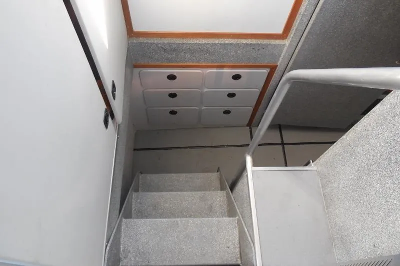Slide: The Image of Interior stairs of 2007 Armstrong Marine 36 Catamaran with storage compartments. - 16