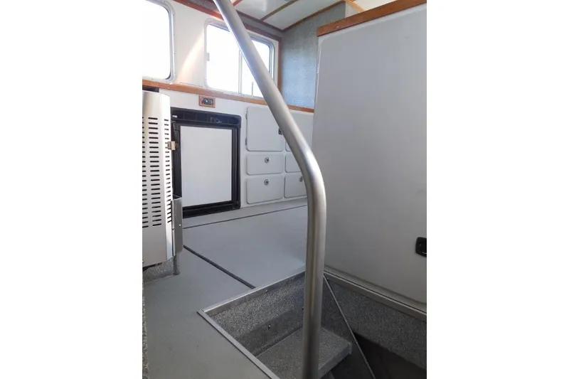 Slide: The Image of Interior of 2007 Armstrong Marine 36 Catamaran with stairs and storage cabinets. - 17