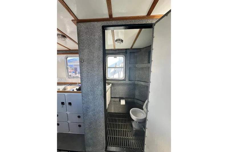 Slide: The Image of Interior of 2007 Armstrong Marine 36 Catamaran featuring bathroom and window view. - 18