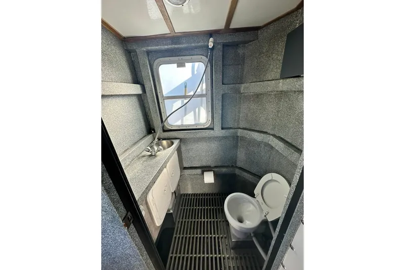 Slide: The Image of 2007 Armstrong Marine 36 Catamaran bathroom with sink, toilet, and window. - 19