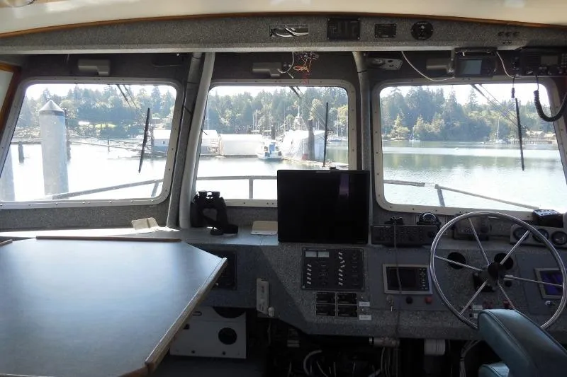 Slide: The Image of Interior view of 2007 Armstrong Marine 36 Catamaran helm with steering wheel and navigation equipment. - 2