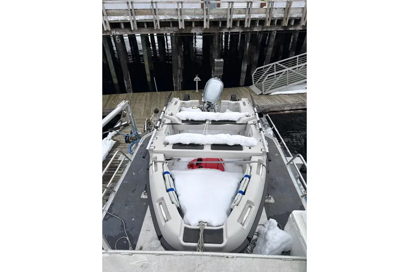 Slide: The Image of 2007 Armstrong Marine 36 Catamaran docked, covered in snow, with visible pier and water. - 25