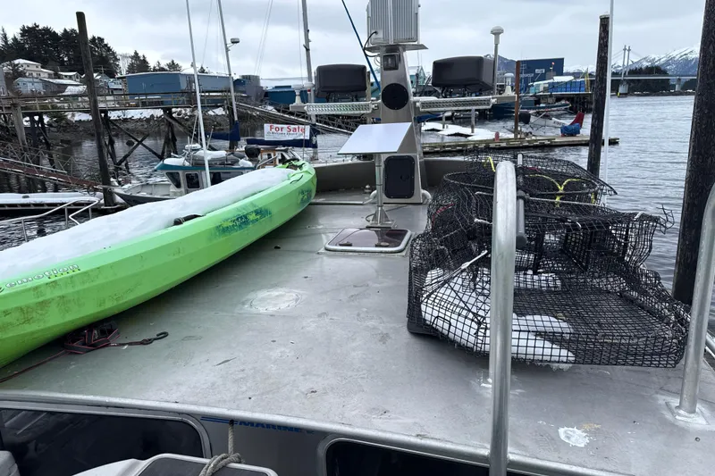 Slide: The Image of 2007 Armstrong Marine 36 Catamaran with kayak and crab pots on deck, docked at marina. - 26