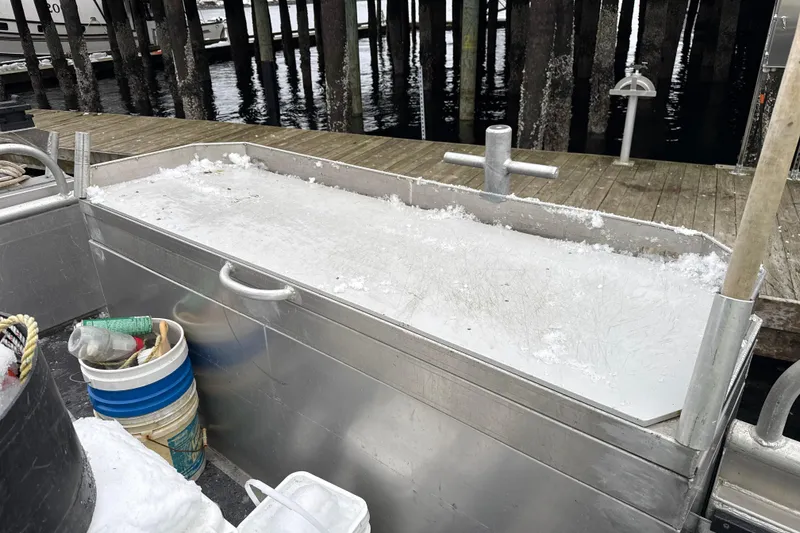 Slide: The Image of Ice-filled storage area on a 2007 Armstrong Marine 36 Catamaran at a dock. - 32