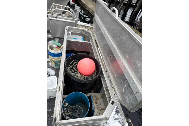 Slide: The Image of Storage compartment on 2007 Armstrong Marine 36 Catamaran with fishing gear and buoy. - 33