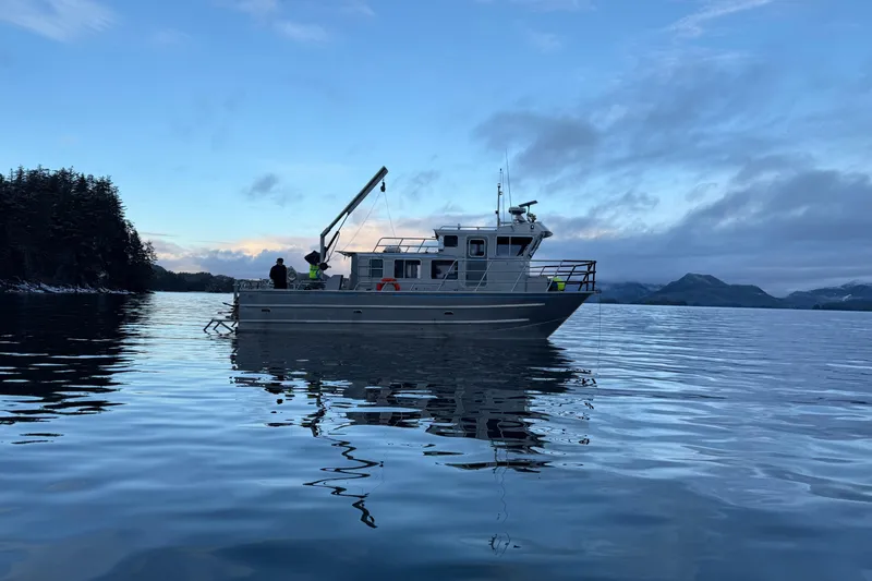 Slide: The Image of Armstrong Marine 36 Catamaran (2007) on calm water at dusk, scenic background. - 37