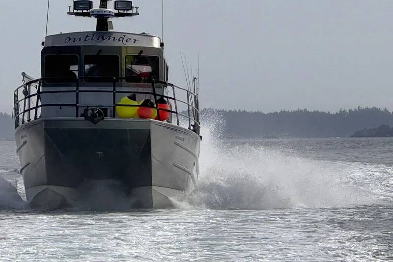 Slide: The Image of Armstrong Marine 36 Catamaran 2007 cruising on open water, creating a dynamic wake. - 39