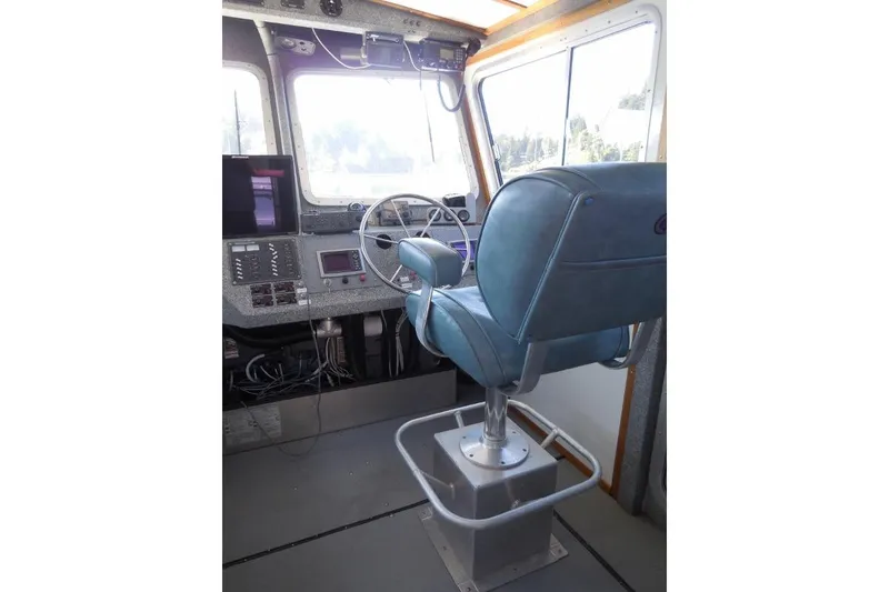 Slide: The Image of Interior cockpit of a 2007 Armstrong Marine 36 Catamaran with steering wheel and control panel. - 4