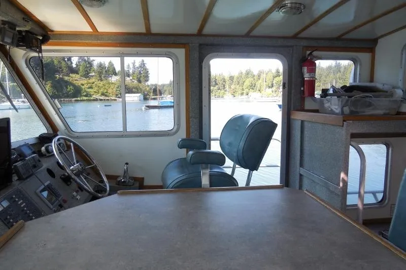 Slide: The Image of Interior of a 2007 Armstrong Marine 36 Catamaran with helm and seating area. - 5