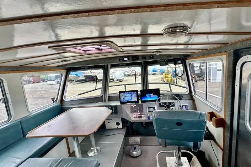 Slide: The Image of Interior of a 2007 Armstrong Marine 36 Catamaran with helm, seating, and navigation equipment. - 6