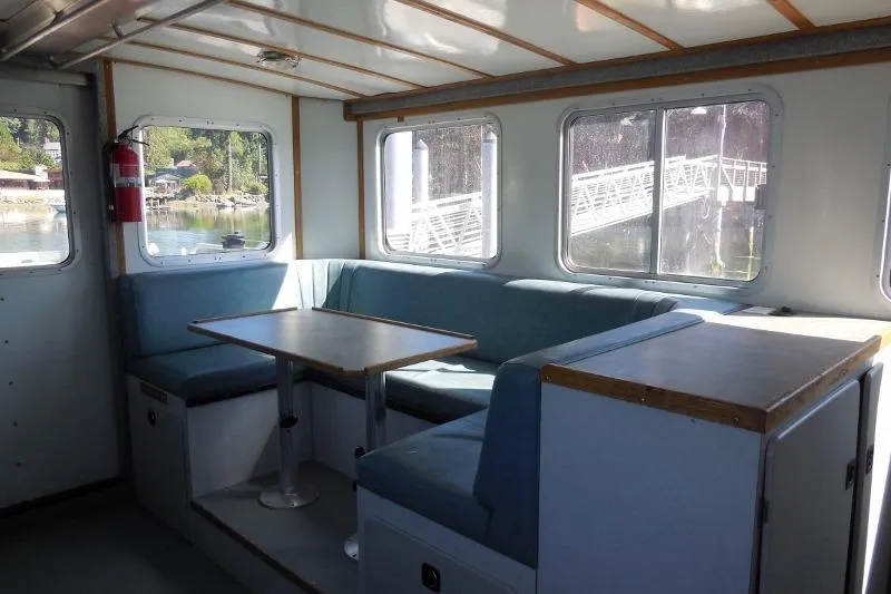 Slide: The Image of Interior of a 2007 Armstrong Marine 36 Catamaran with seating and table. - 7