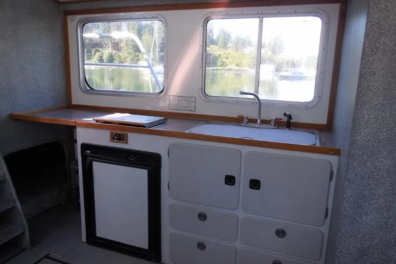 Slide: The Image of Interior of 2007 Armstrong Marine 36 Catamaran with kitchenette and scenic window view. - 8