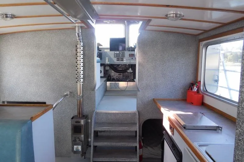 Slide: The Image of Interior of a 2007 Armstrong Marine 36 Catamaran, featuring helm and galley area. - 9