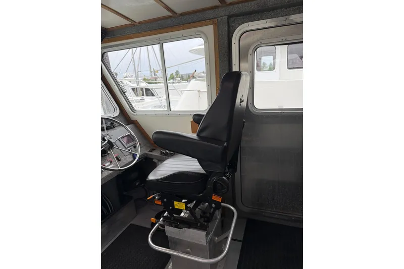 Slide: The Image of Interior of a 2007 Armstrong Marine 36 Catamaran, featuring a captain's chair and steering wheel. - 3