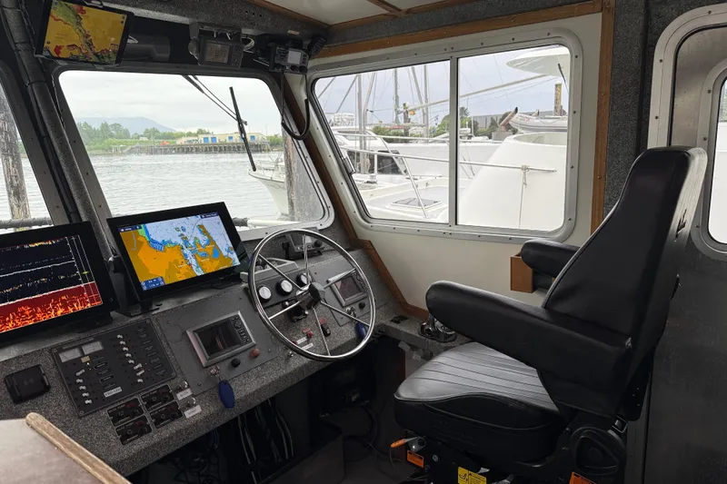 Slide: The Image of Interior of a 2007 Armstrong Marine 36 Catamaran cockpit with navigation equipment and captain's chair. - 2