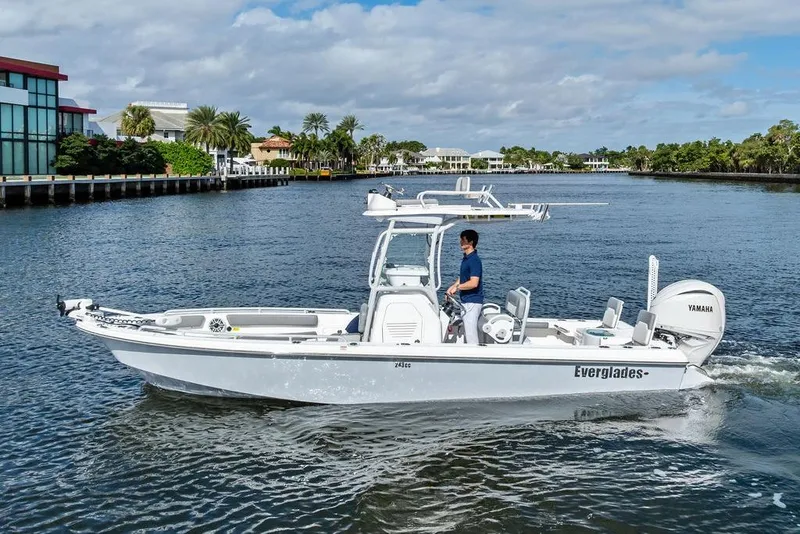 Slide: The Image of 2023 Everglades 243 Center Console boat cruising on a scenic waterway. - 10