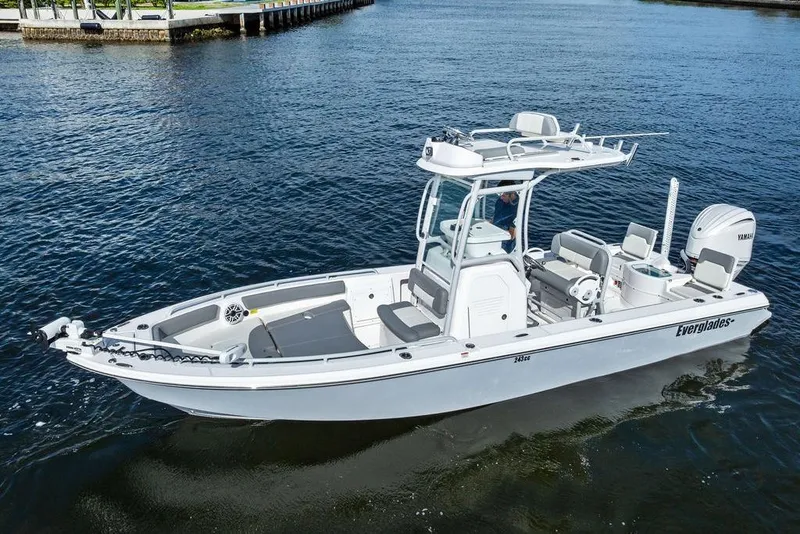 Slide: The Image of 2023 Everglades 243 Center Console boat on calm water, showcasing sleek design and modern features. - 11