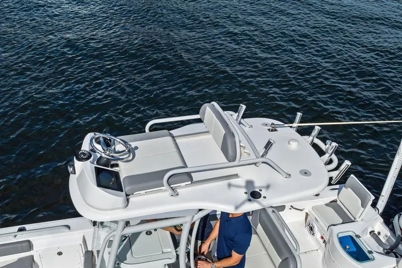 Slide: The Image of 2023 Everglades 243 Center Console boat on water, featuring sleek design and modern controls. - 13