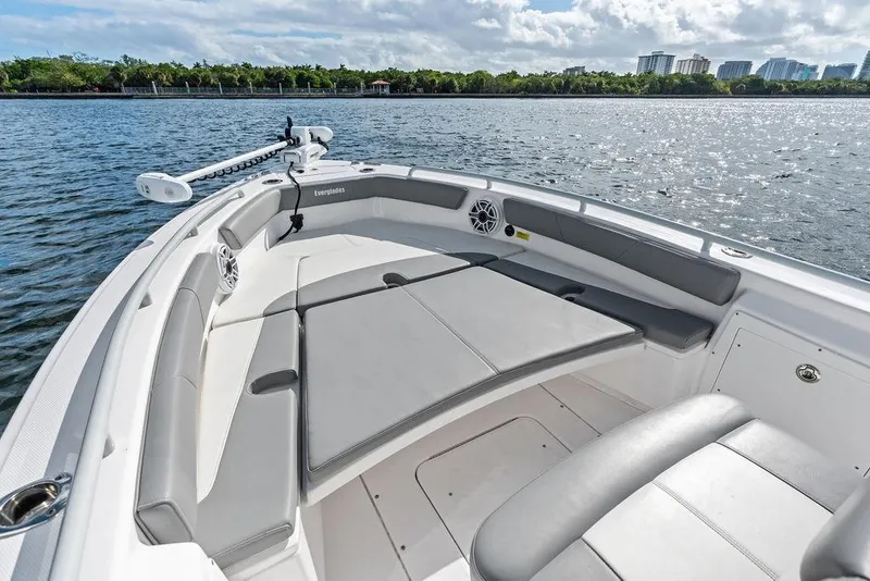 Slide: The Image of 2023 Everglades 243 Center Console boat with spacious seating on calm water. - 16