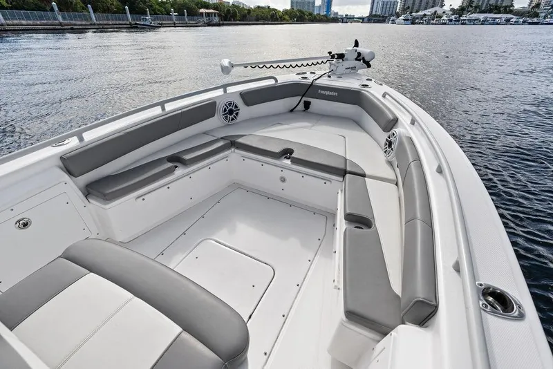 Slide: The Image of 2023 Everglades 243 Center Console boat interior with gray seating on calm water. - 23