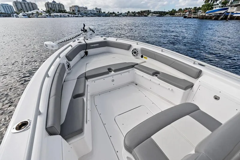 Slide: The Image of 2023 Everglades 243 Center Console boat interior with gray seating on calm water. - 24