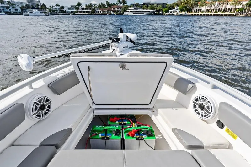 Slide: The Image of 2023 Everglades 243 Center Console boat with open storage compartment and marine batteries. - 25