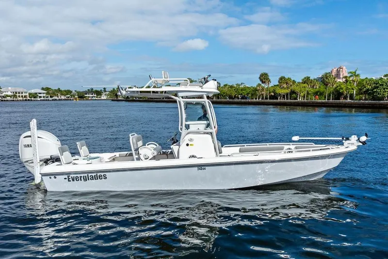 Slide: The Image of 2023 Everglades 243 Center Console boat on calm water, showcasing sleek design and modern features. - 3