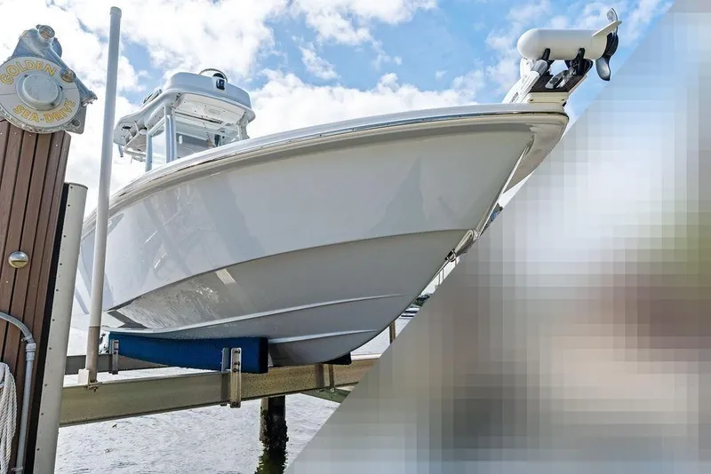 Slide: The Image of 2023 Everglades 243 Center Console boat on a boat lift. - 31