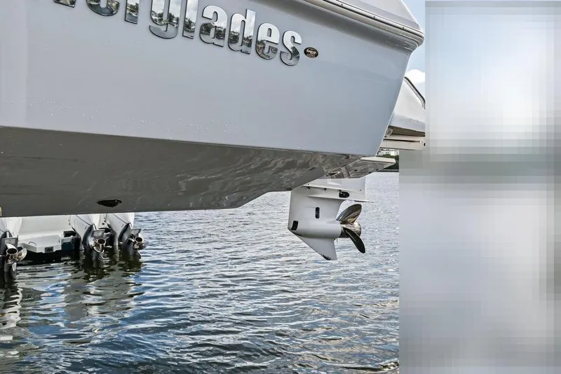 Slide: The Image of Everglades 243 Center Console 2023 boat hull and engines on water. - 32