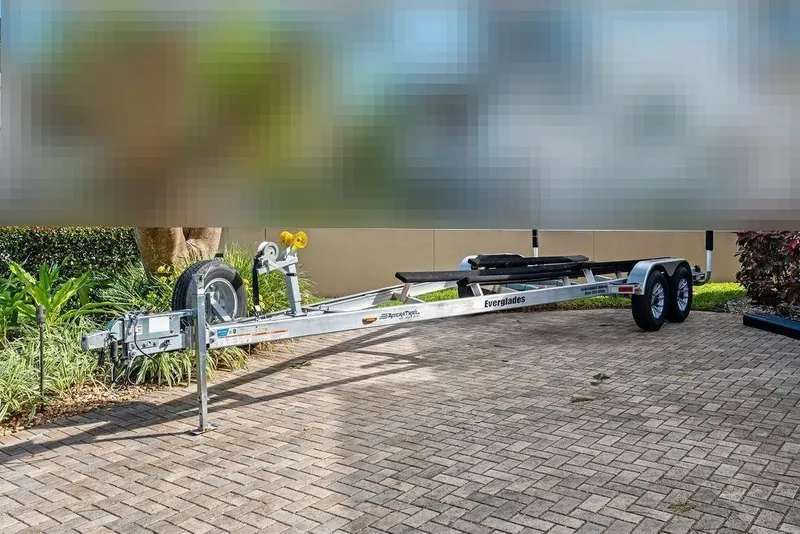 Slide: The Image of Boat trailer for Everglades 243 Center Console 2023 on paved path. - 35