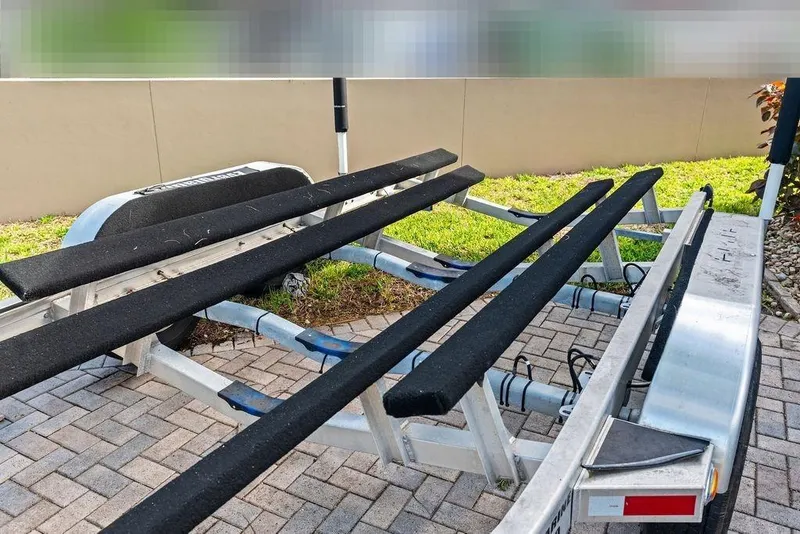 Slide: The Image of Boat trailer for Everglades 243 Center Console 2023 on paved surface. - 37