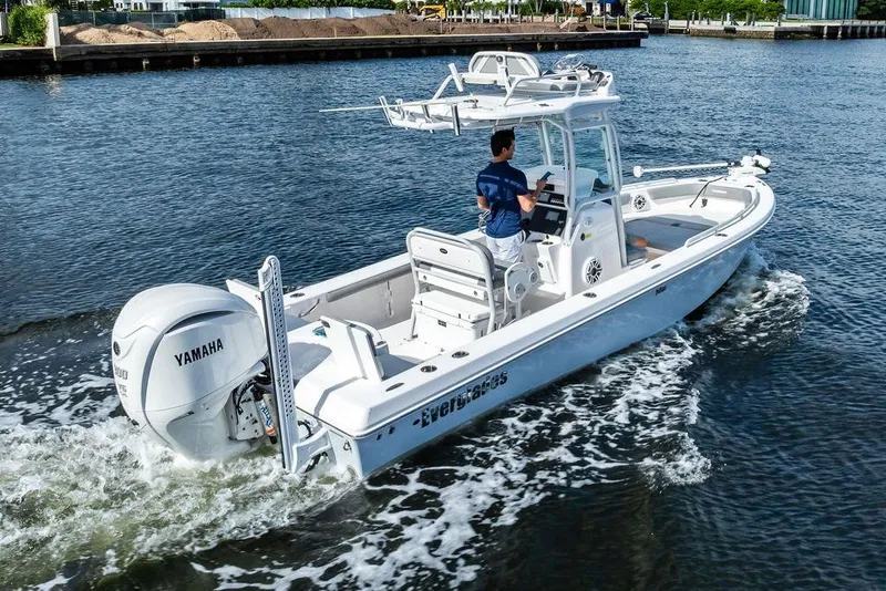 Slide: The Image of 2023 Everglades 243 Center Console boat cruising on water with Yamaha engine. - 4
