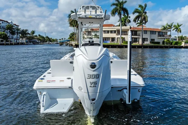 Slide: The Image of 2023 Everglades 243 Center Console boat on water, palm trees in background. - 7