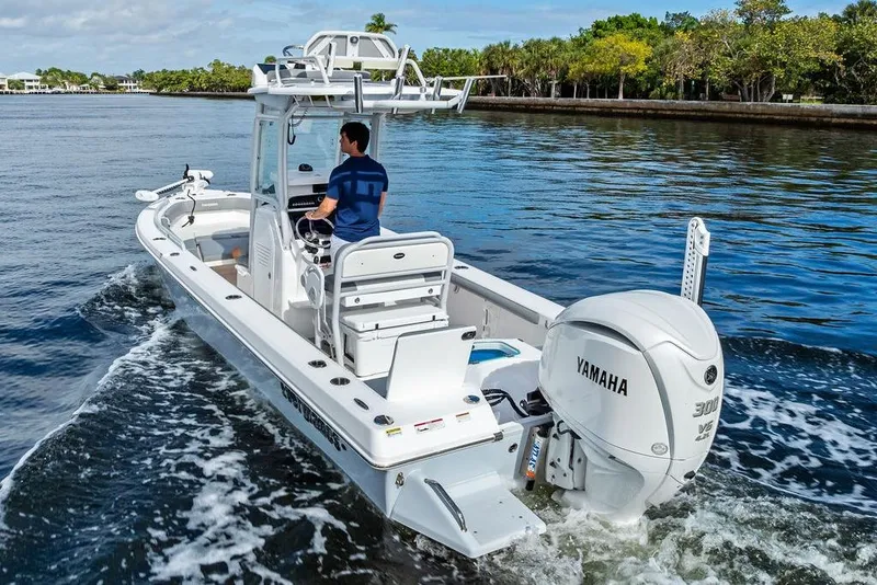 Slide: The Image of 2023 Everglades 243 Center Console boat cruising on water with Yamaha engine. - 8
