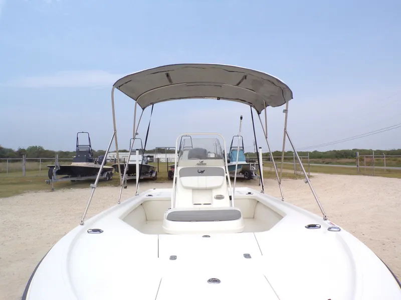 Slide: The Image of 2022 Mako 18 LTS boat with canopy on sandy ground. - 22