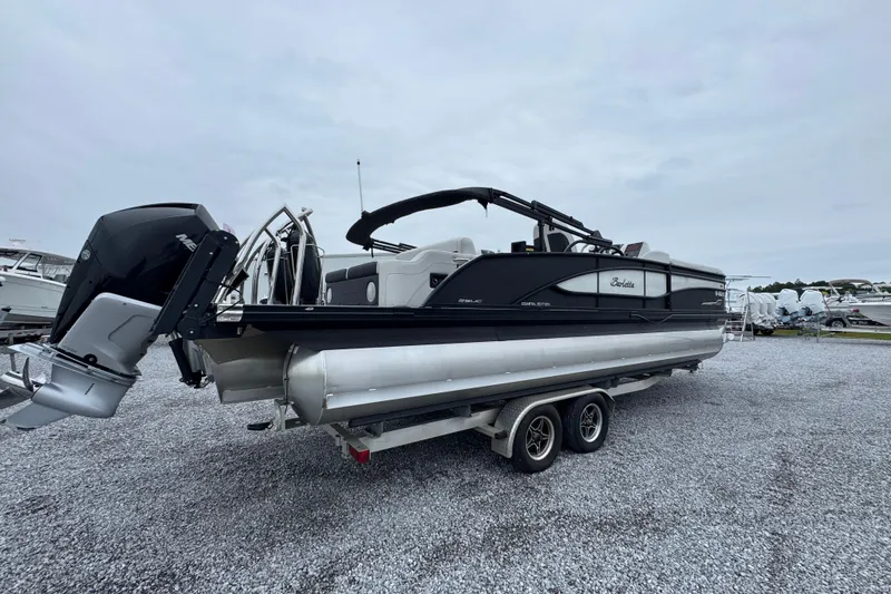 Slide: The Image of 2023 Barletta CORSA 25UC pontoon boat on trailer, displayed outdoors. - 10