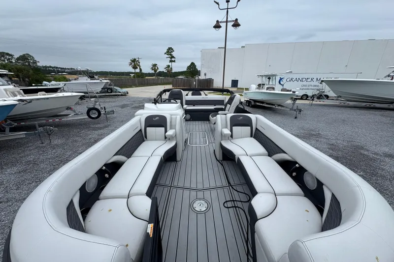Slide: The Image of 2023 Barletta CORSA 25UC pontoon boat with spacious seating, displayed outdoors. - 16