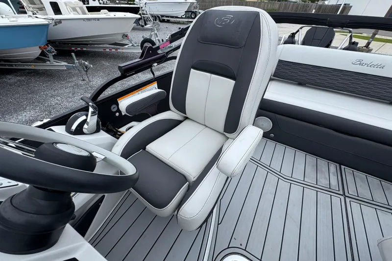 Slide: The Image of Captain's seat of 2023 Barletta CORSA 25UC boat, featuring sleek design and modern controls. - 21