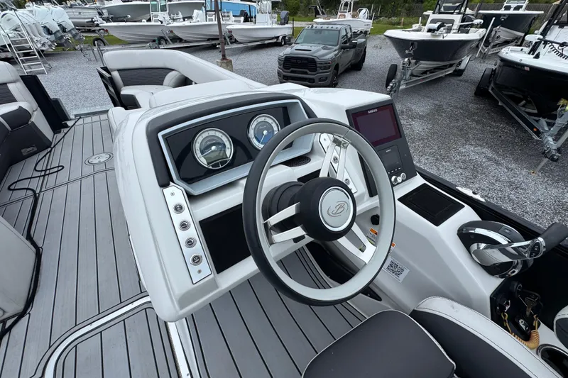 Slide: The Image of 2023 Barletta CORSA 25UC boat dashboard with steering wheel and controls. - 22