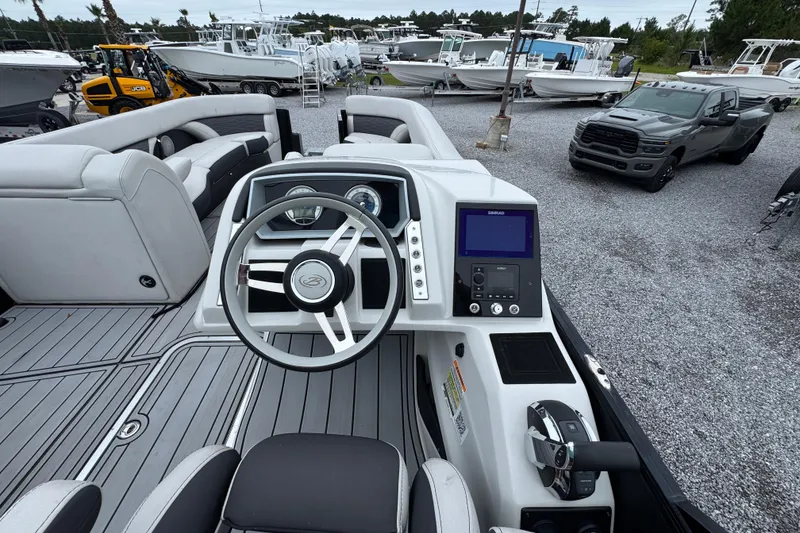 Slide: The Image of 2023 Barletta CORSA 25UC boat interior with steering wheel and control panel. - 23