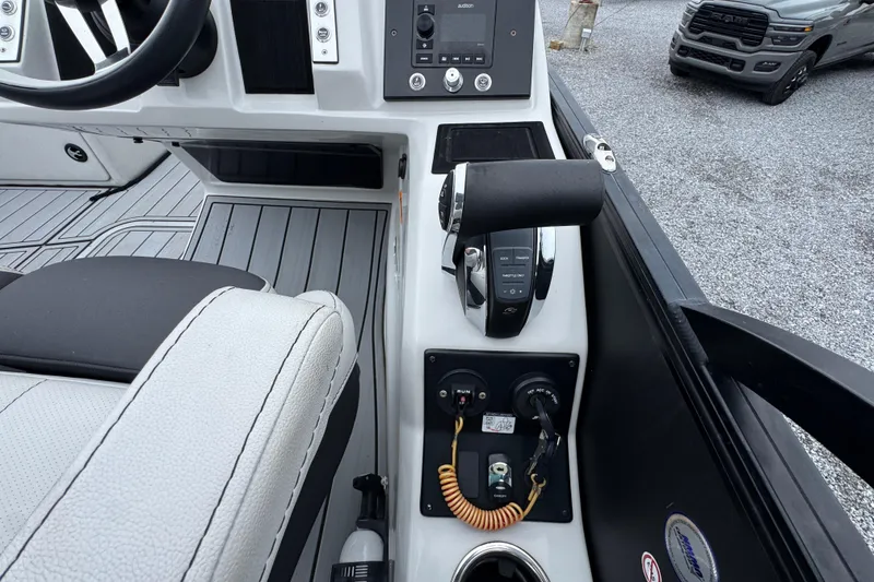 Slide: The Image of 2023 Barletta CORSA 25UC boat cockpit with steering wheel and control panel. - 25