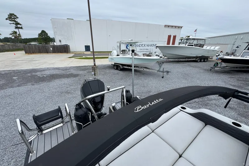 Slide: The Image of 2023 Barletta CORSA 25UC pontoon boat at a marina with other boats. - 29