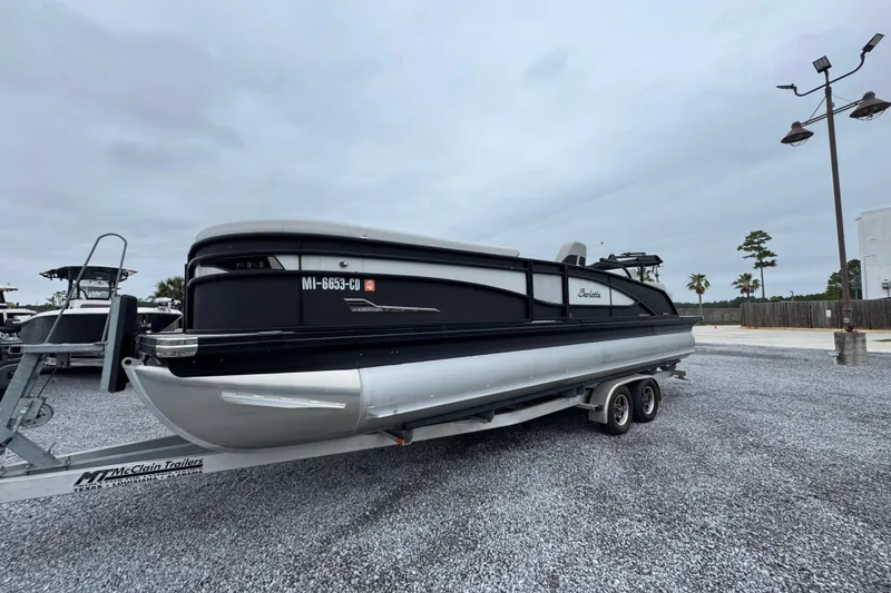 Slide: The Image of 2023 Barletta CORSA 25UC pontoon boat on trailer in parking lot. - 3