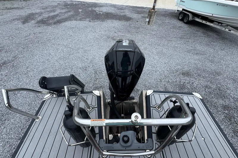 Slide: The Image of 2023 Barletta CORSA 25UC boat with Mercury outboard motor on a gravel surface. - 30
